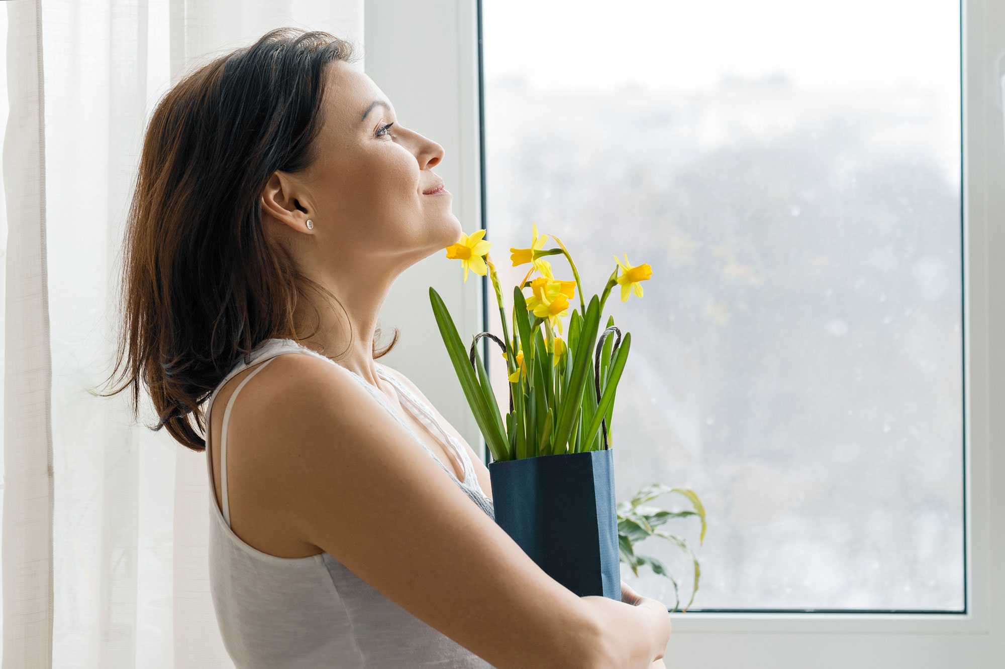 Woman enjoying fresh air inside her home