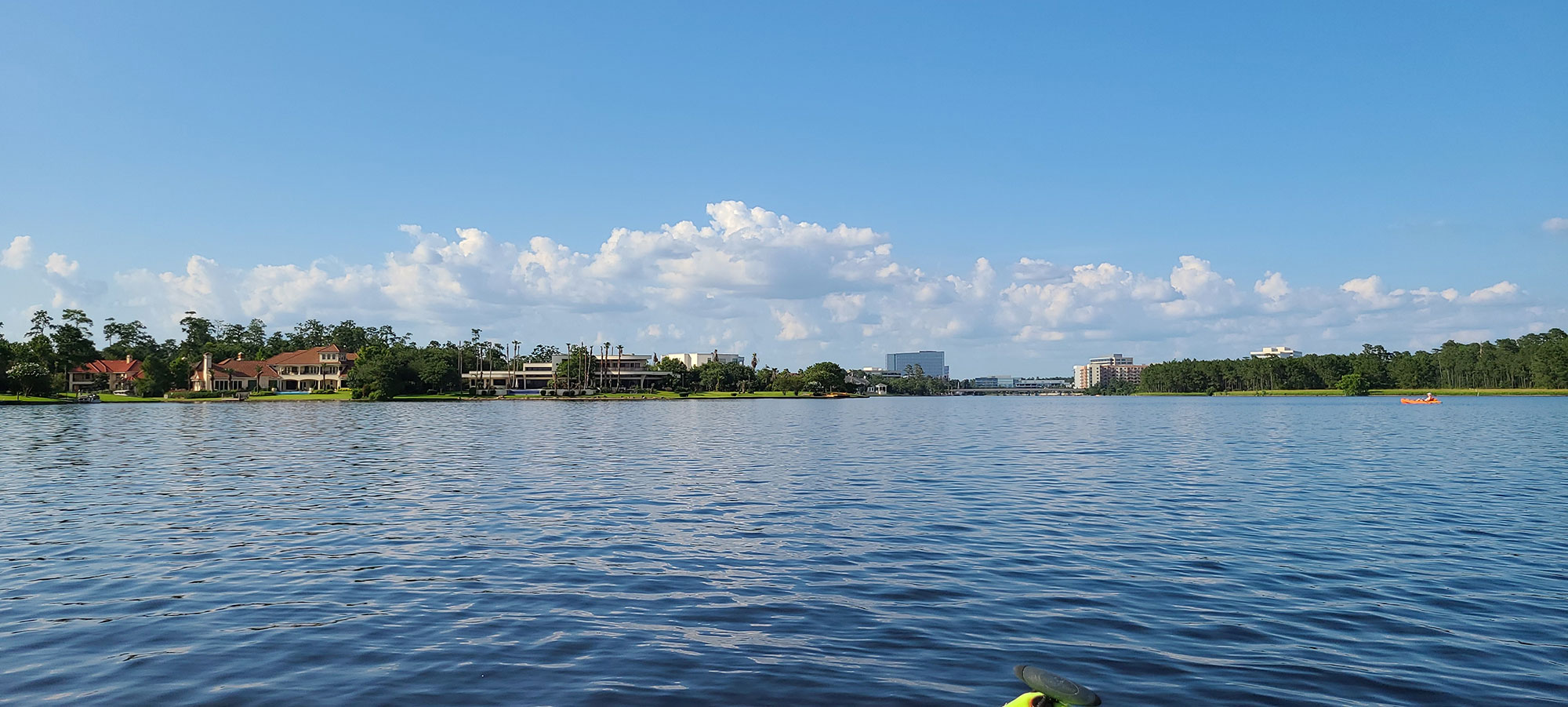 lake woodlands with luxury homes on the horizon