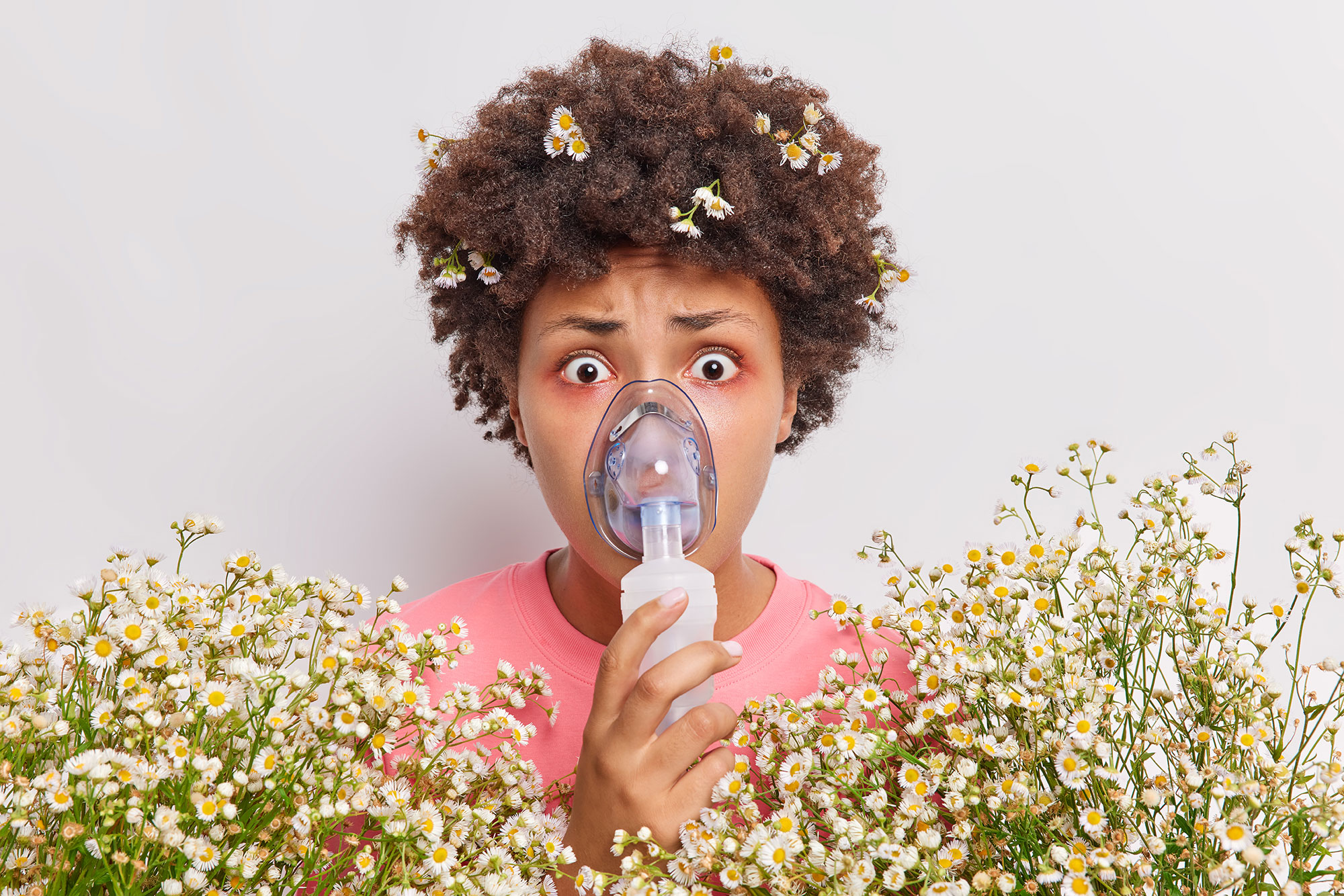 Woman wearing a breathing mask with flowers below